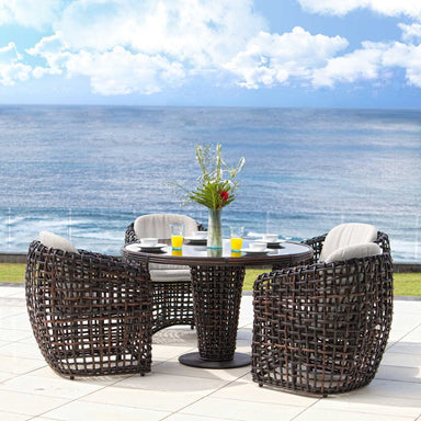 Outdoor patio set with table and chairs by the ocean