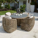 Outdoor patio set with wicker chairs and table in a garden setting