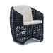 Wicker chair with beige cushion on a white background