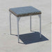 Small square table with a tiled top on a concrete surface