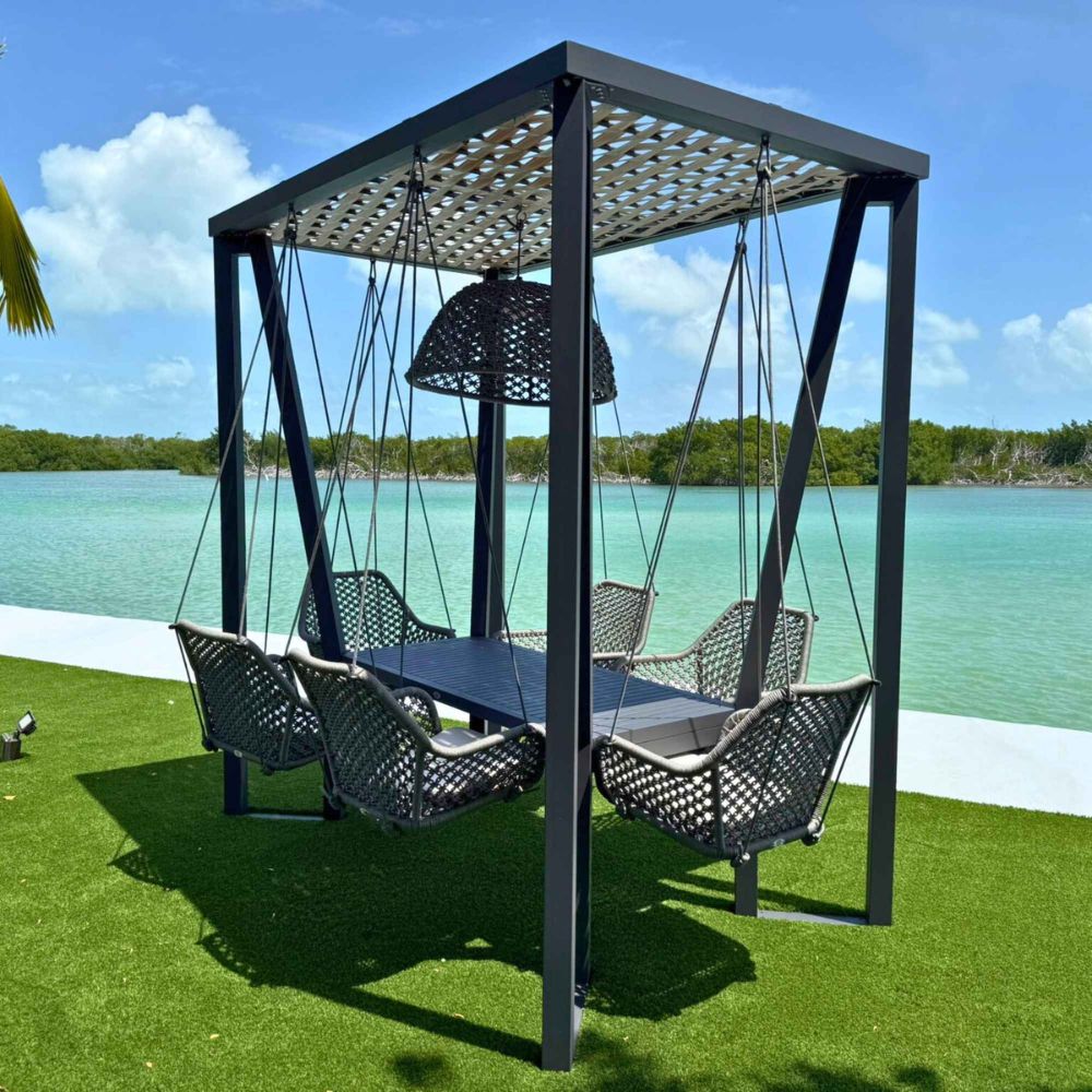 Outdoor swing set with canopy by a body of water