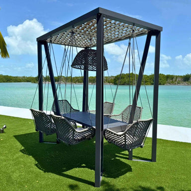 Outdoor swing set with canopy by a body of water