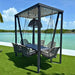 Outdoor swing set with canopy by a body of water