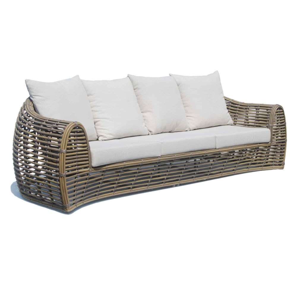 Wicker outdoor sofa with white cushions on a white background