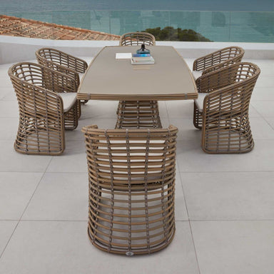 Outdoor dining set with a table and six chairs on a tiled patio.