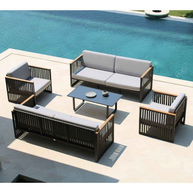 Outdoor patio furniture set with gray cushions by a pool