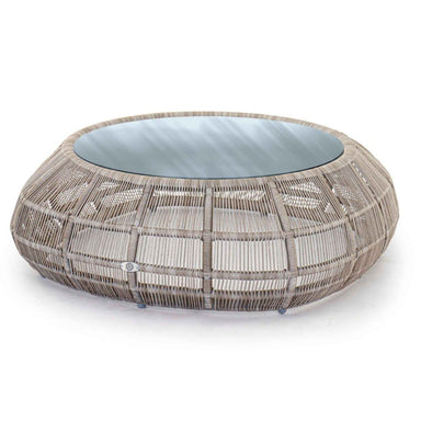 Round woven outdoor table with glass top on a white background