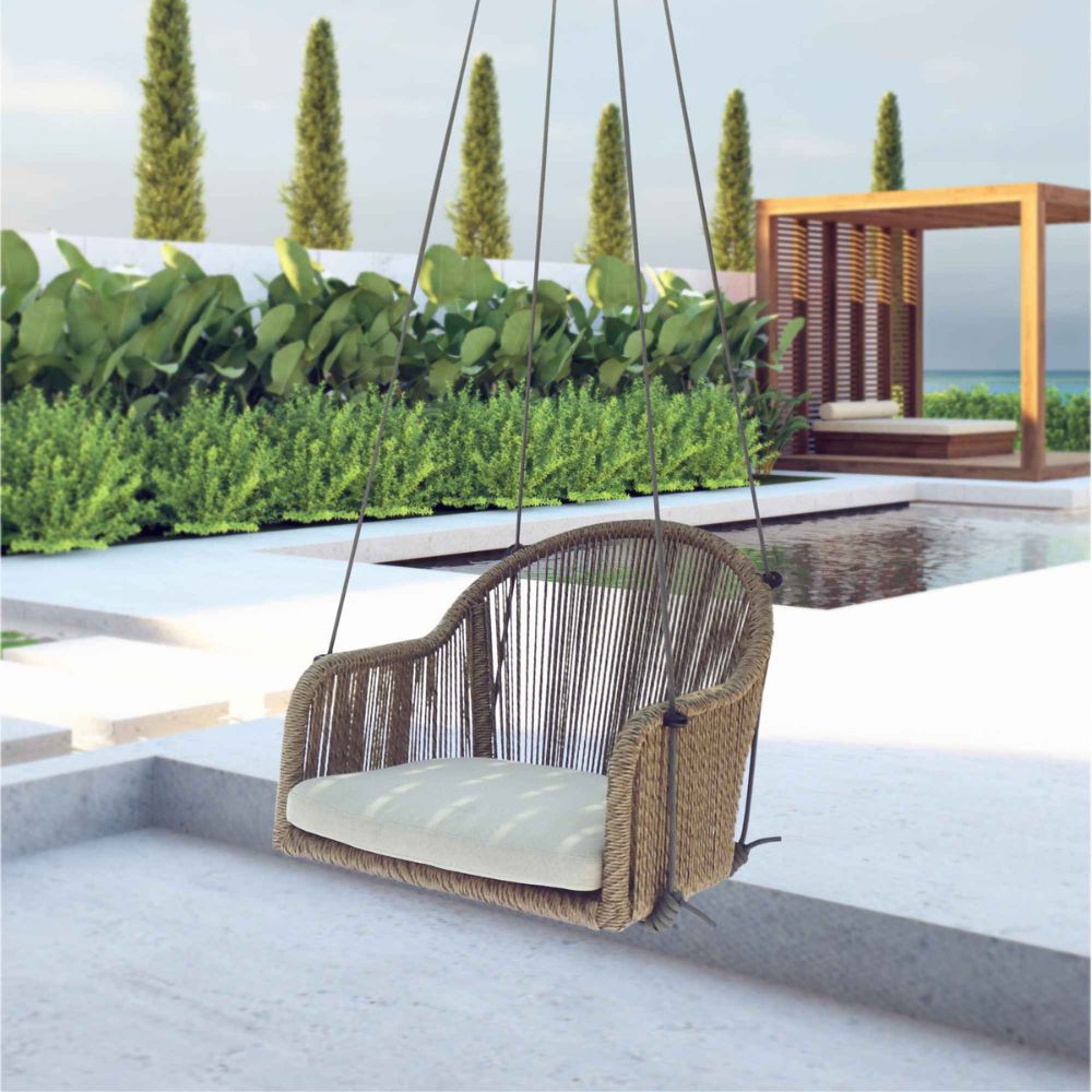 Woven chair swing with beige cushion in a modern outdoor setting with pool and greenery.