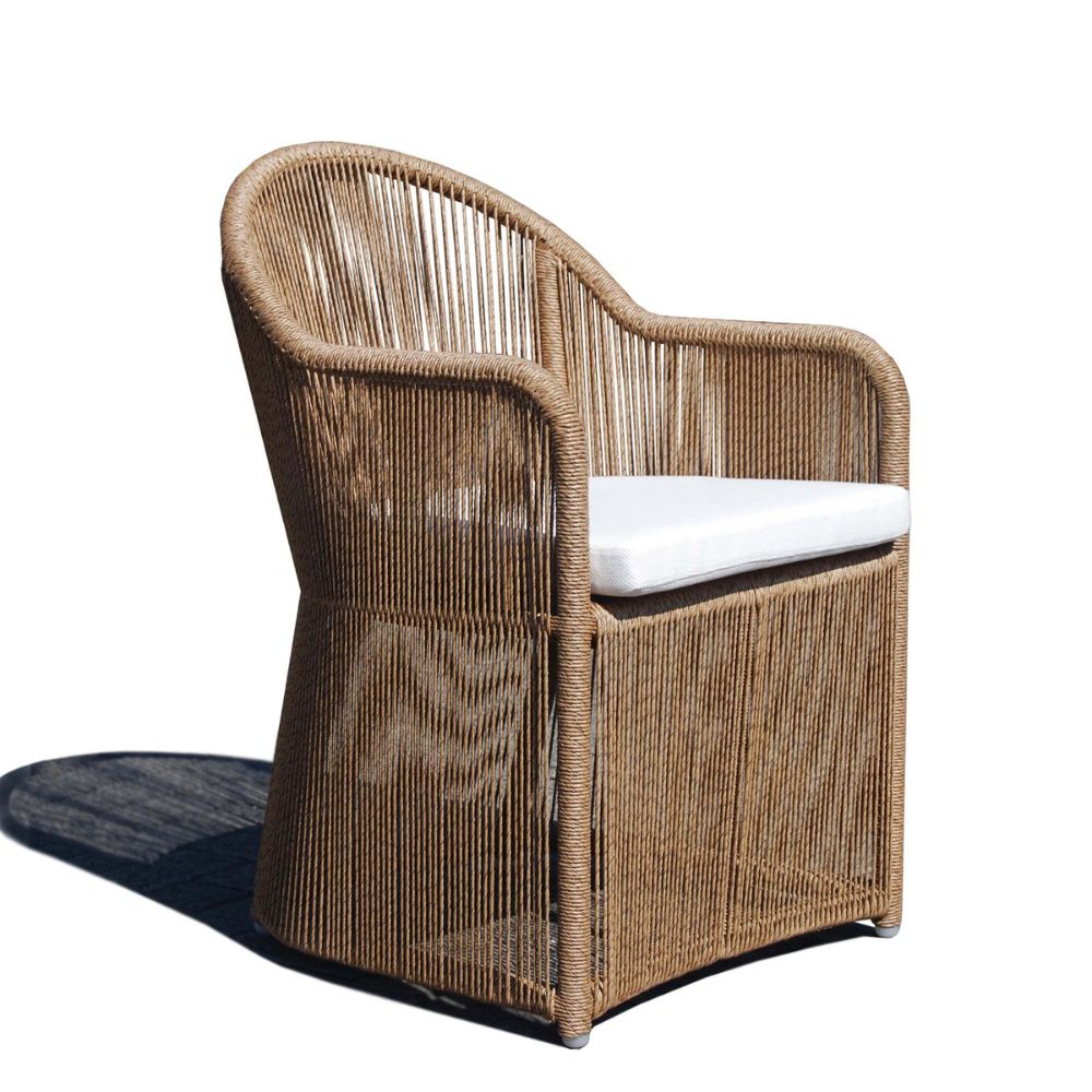 Wicker chair with a white cushion on a white background