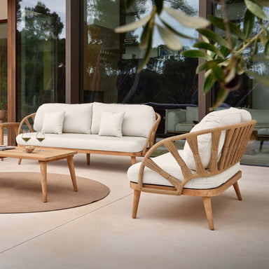 Outdoor furniture set with a sofa and chair on a patio