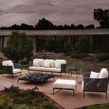 Outdoor patio set with furniture and drinks on a patio area.