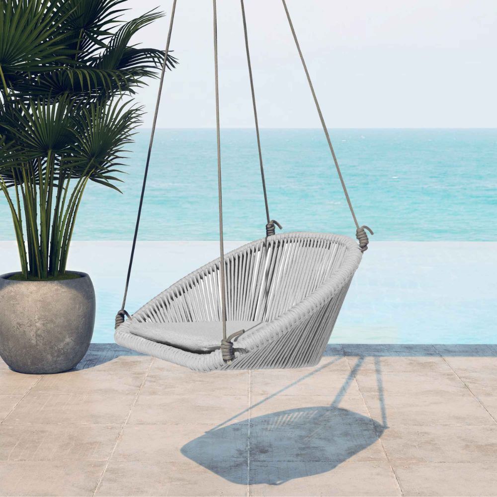 Gray hanging chair on a patio with ocean view