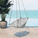 Gray hanging chair on a patio with ocean view