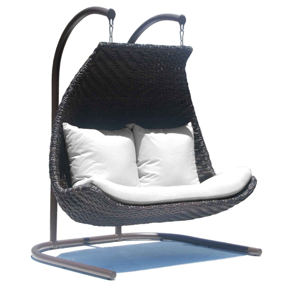 Hanging chair with black wicker design and white cushions on a white background