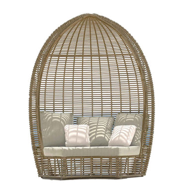 Wicker egg-shaped chair with cushions on a white background