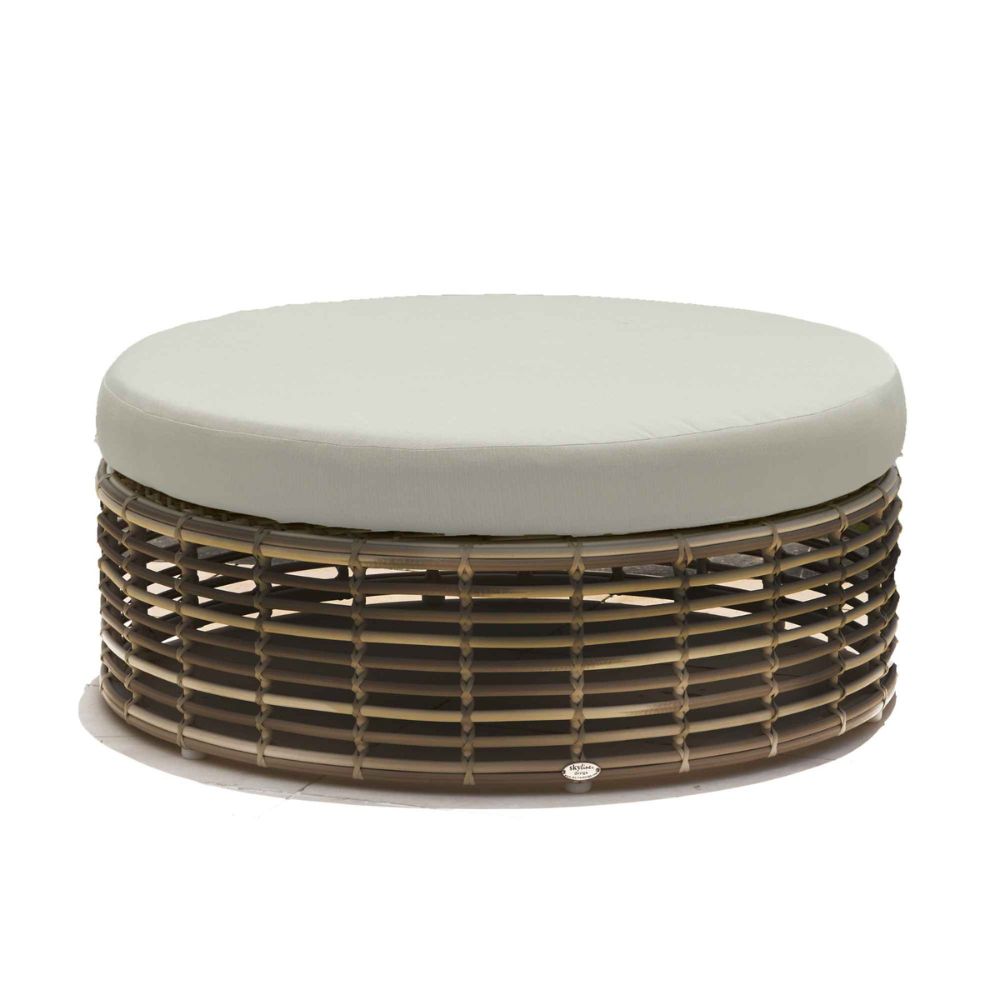 Round ottoman with woven base and light gray cushion on a white background