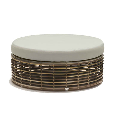 Round ottoman with woven base and light gray cushion on a white background