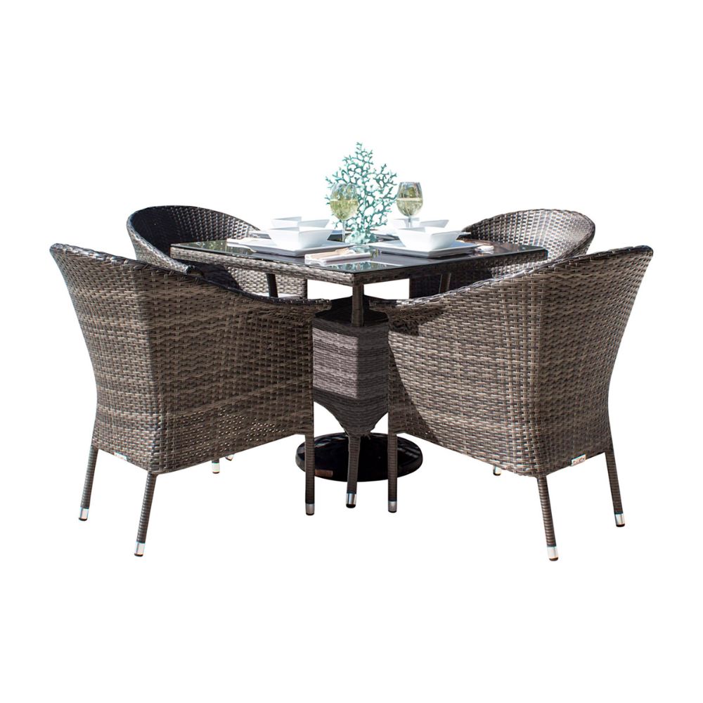 Outdoor dining set with four wicker chairs and a round table on a white background