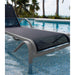 Gray lounge chair with black mesh seat by a poolside