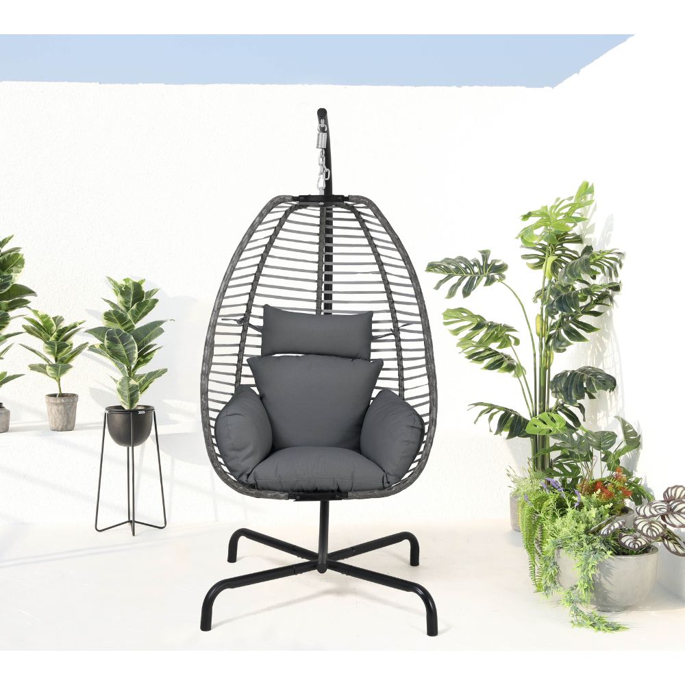 Hanging egg chair with gray cushions in a room with plants