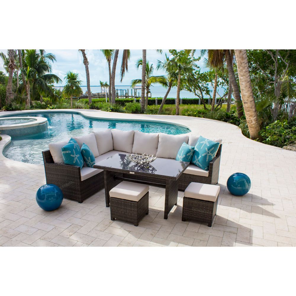 Outdoor patio furniture set with cushions by a poolside