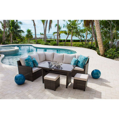 Outdoor patio furniture set with cushions by a poolside