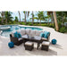 Outdoor patio furniture set with cushions by a poolside
