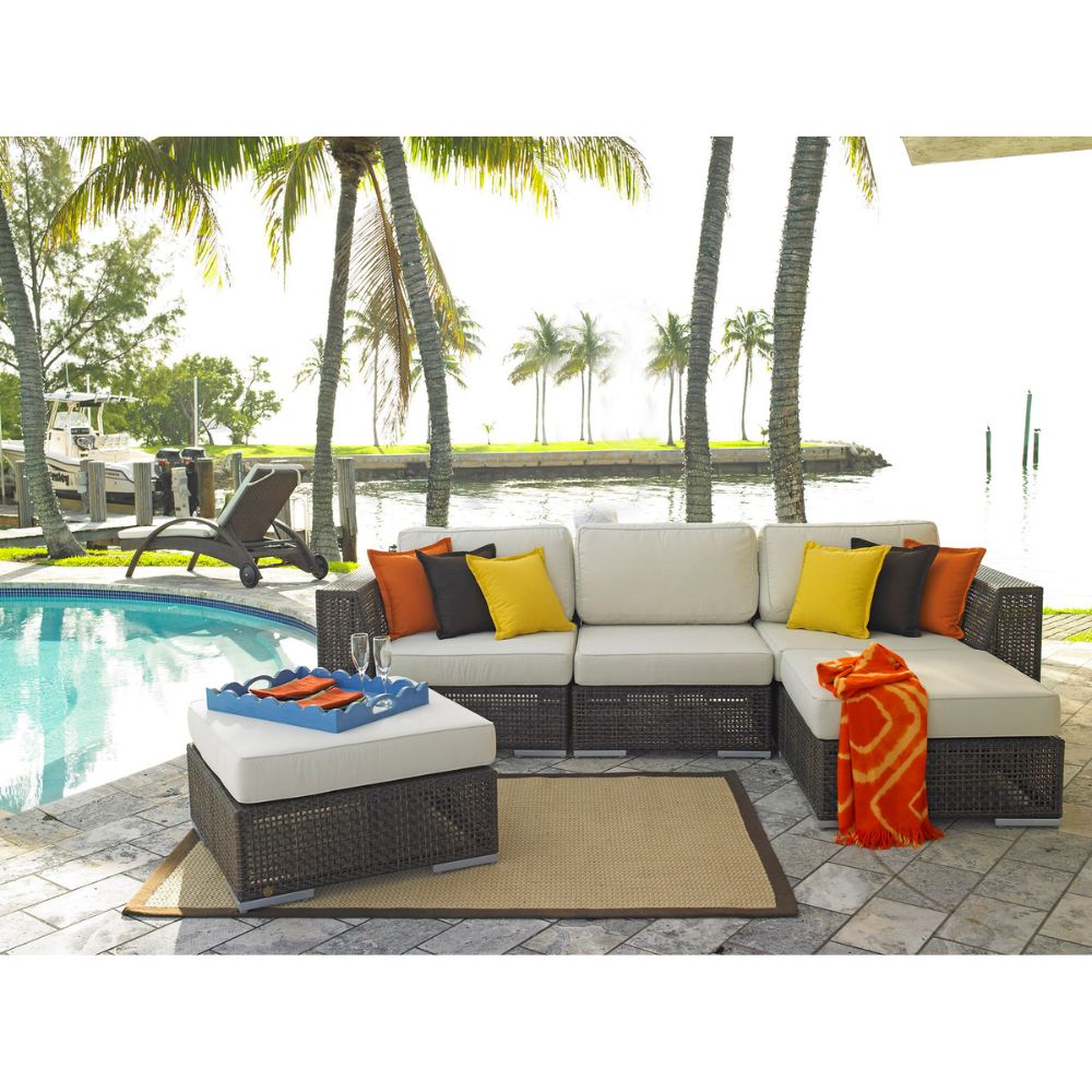 Outdoor patio furniture set with cushions by a poolside