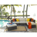 Outdoor patio furniture set with cushions by a poolside