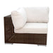 Brown wicker chair with white cushions on a white background