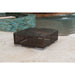 Square woven outdoor table with a dark top on a patio near a pool.