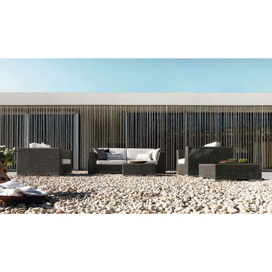 Outdoor patio furniture set on a pebble-covered ground with a clear blue sky.