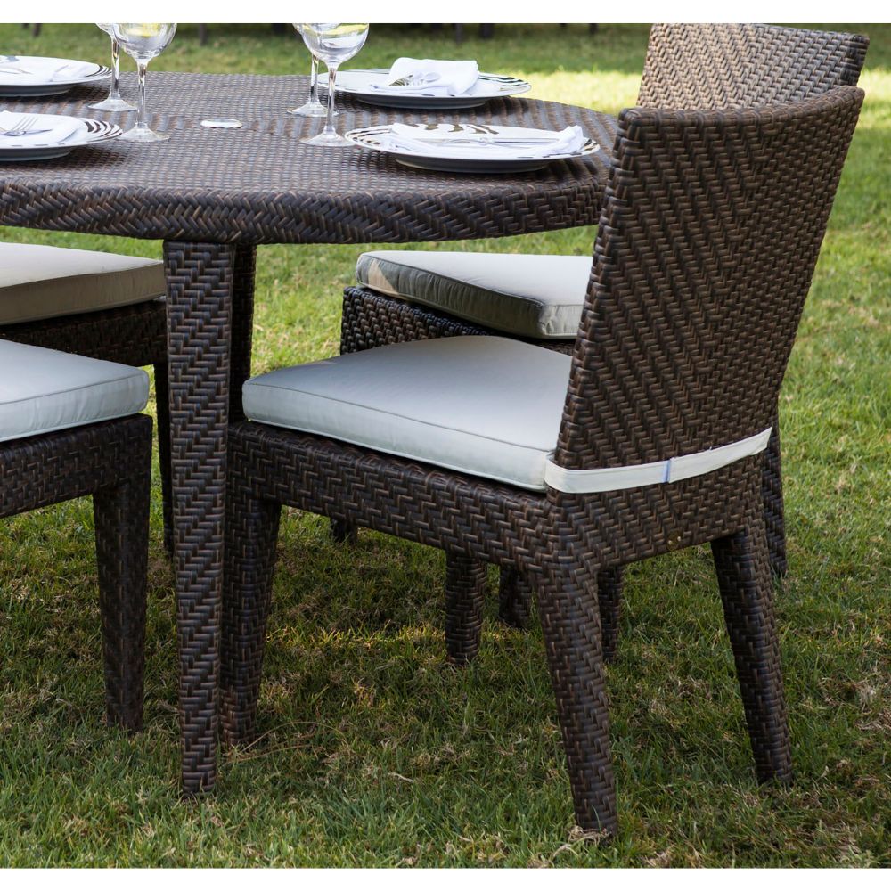 Outdoor dining set with wicker table and chairs on grass
