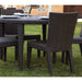 Outdoor dining set with wicker chairs and table on grass