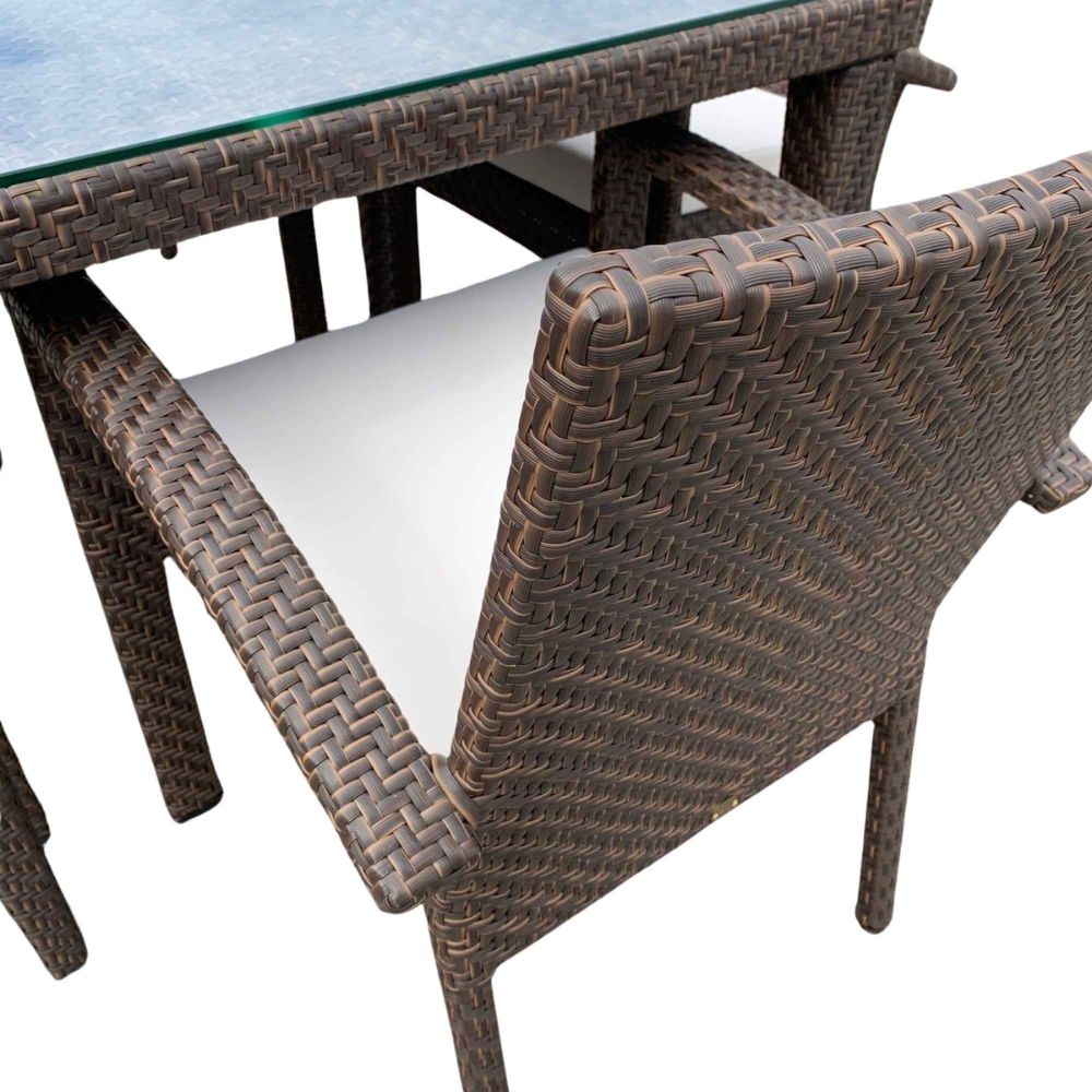 Brown wicker chair and table set on a white background