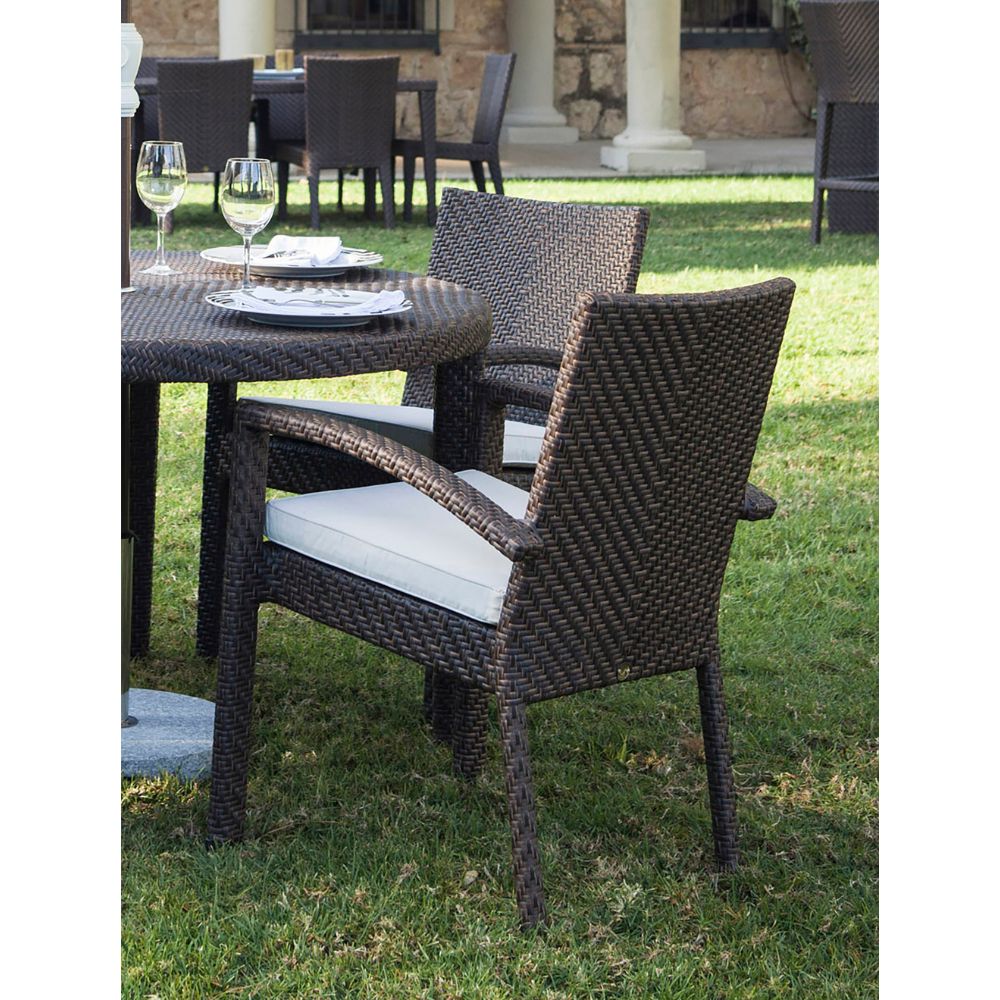 Outdoor patio set with wicker chairs and table on grass