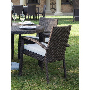 Outdoor patio set with wicker chairs and table on grass