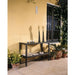 Wrought iron console table with decorative items against a yellow wall