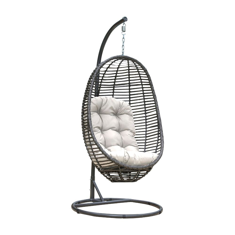 Black wicker hanging chair with white cushion on a white background