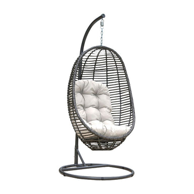 Black wicker hanging chair with white cushion on a white background