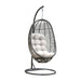 Black wicker hanging chair with white cushion on a white background