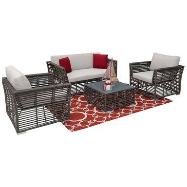 Outdoor furniture set with chairs, sofa, and table on a red patterned rug