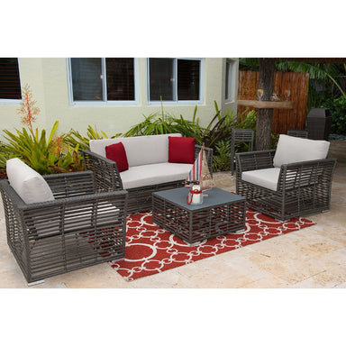 Outdoor patio furniture set with gray wicker chairs and white cushions on a red and beige rug.