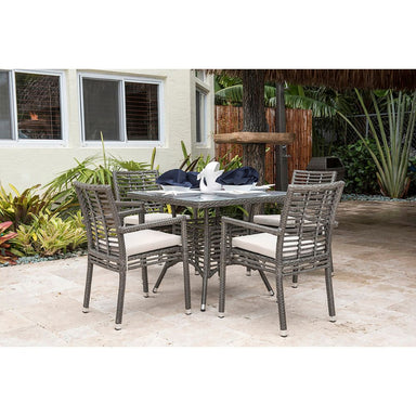 Outdoor patio set with table and chairs on a patio area.
