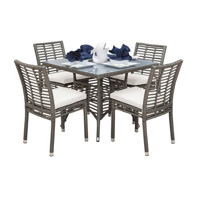 Outdoor dining set with four chairs and a table on a white background