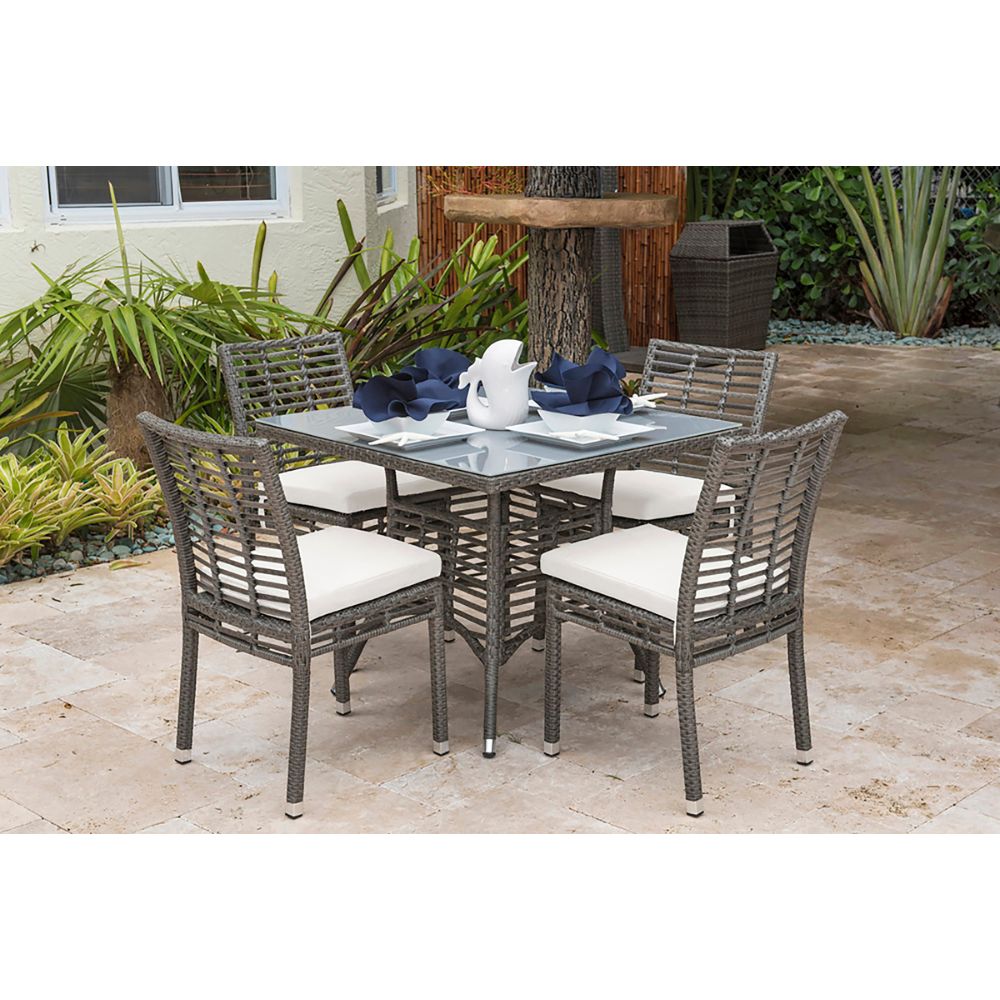 Outdoor patio set with table and chairs on a stone patio
