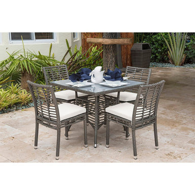 Outdoor patio set with table and chairs on a stone patio