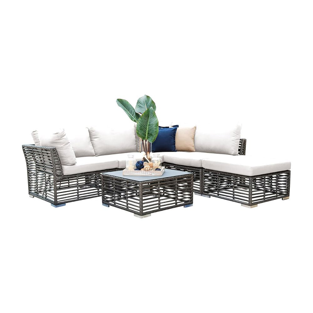 Outdoor patio furniture set with a table and cushions on a white background
