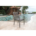 Chair by a pool with a fountain and scenic background