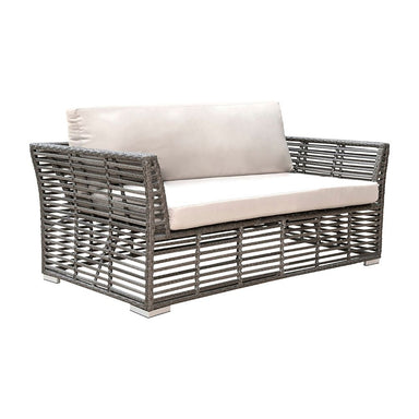 Wicker outdoor loveseat with beige cushions on a white background